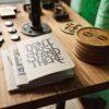 three gray papers near round brown wooden boards on table