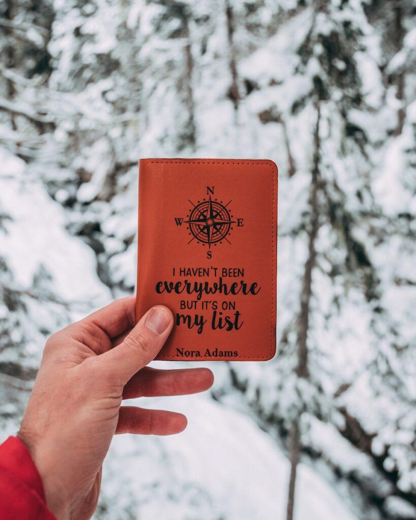 person holding brown pocket book