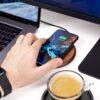 charging iPhone in front of turned on monitor