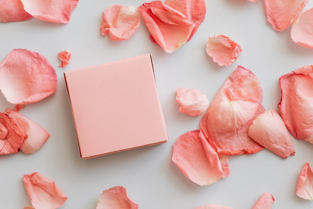 Gift in pink box with scattered petals around