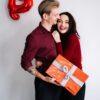 A Man Holding a Gift Box Near a Woman