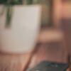 black smartphone on white ceramic mug