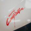 White Car Hood with Red Sticker