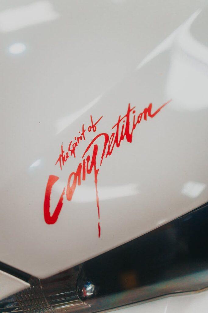 White Car Hood with Red Sticker
