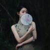a woman with a fan in her hand