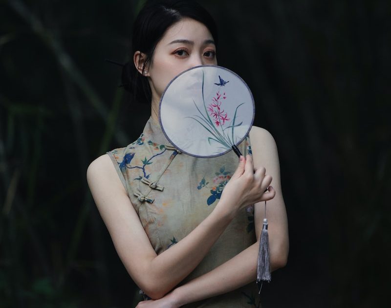 a woman with a fan in her hand