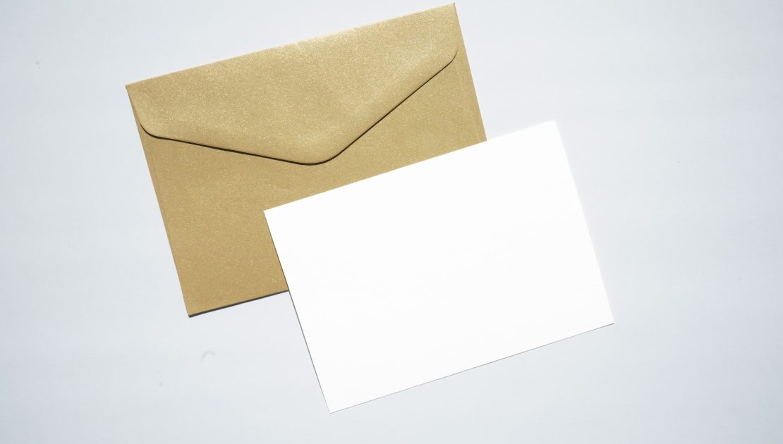 white printer paper on brown envelope