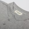 gray polo shirt on white table