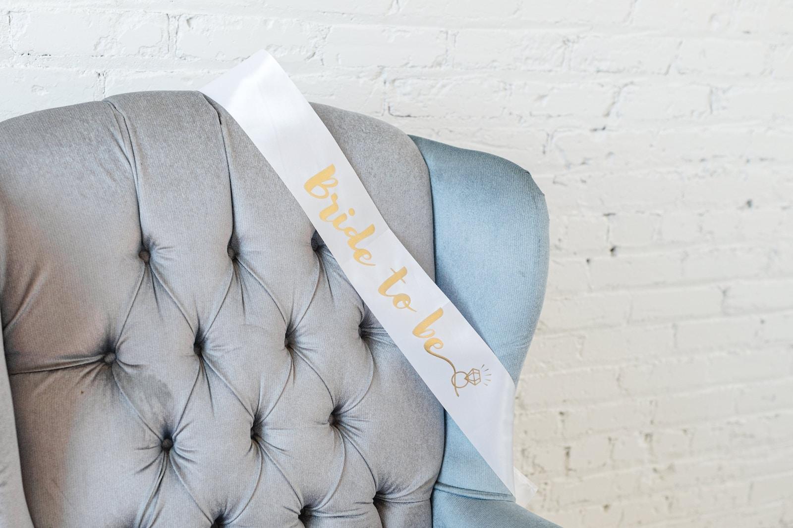 a blue chair with a white ribbon on it