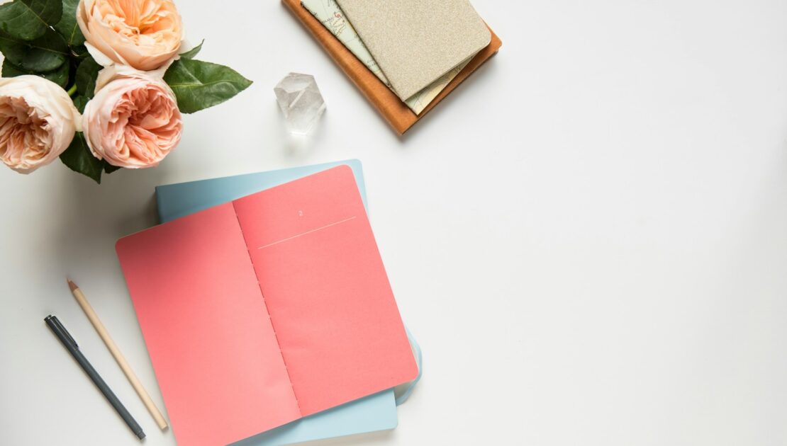 pink covered book in top view photography